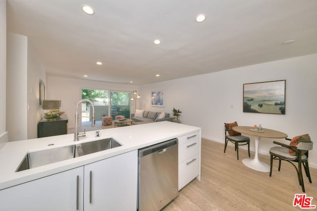 kitchen with white cabinets, dishwasher, sink, and light hardwood / wood-style floors