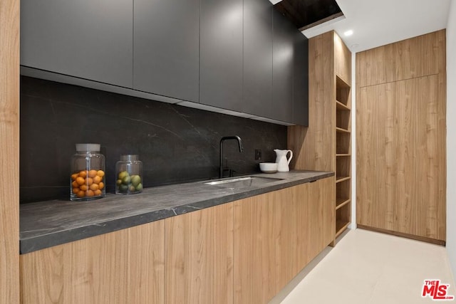 kitchen featuring decorative backsplash and sink