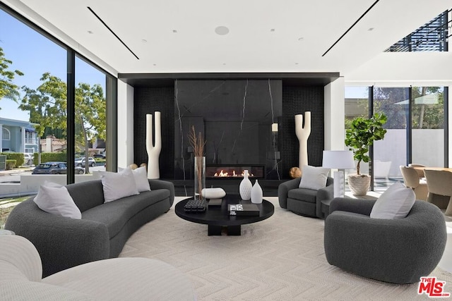 living room with a premium fireplace and floor to ceiling windows