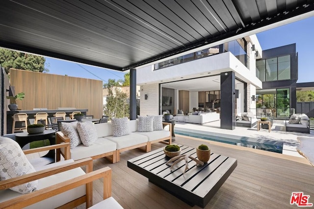 view of patio featuring an outdoor living space and a swimming pool side deck