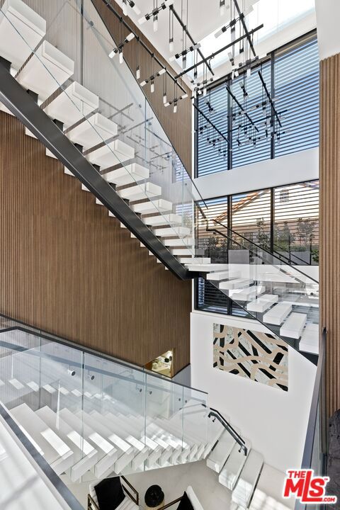 staircase featuring a high ceiling