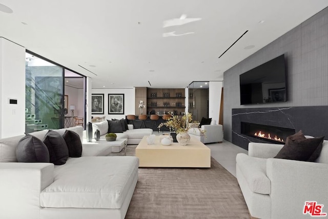 living room featuring expansive windows and a high end fireplace