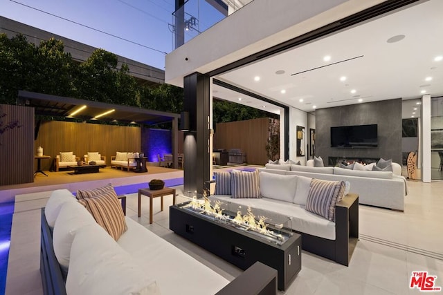 view of patio featuring an outdoor living space with a fireplace