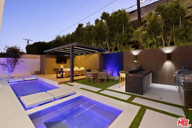 view of swimming pool with an outdoor hangout area, a patio area, and exterior bar