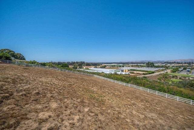 view of yard with a rural view