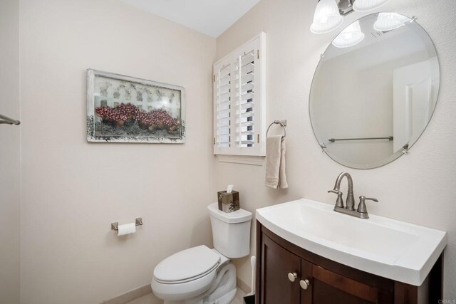 bathroom featuring toilet and vanity