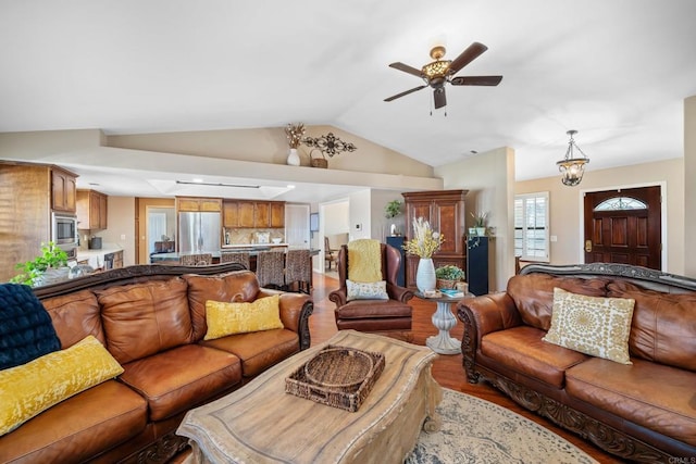 living room with ceiling fan, lofted ceiling, and wood-type flooring