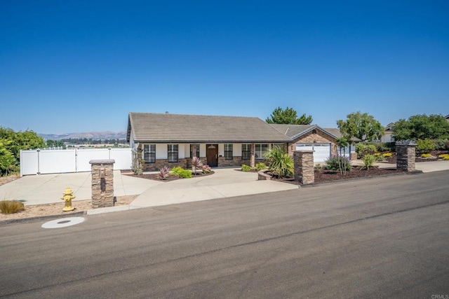 view of front of property featuring a garage and a mountain view