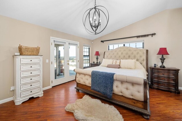 bedroom featuring dark wood-type flooring, lofted ceiling, access to outside, and an inviting chandelier