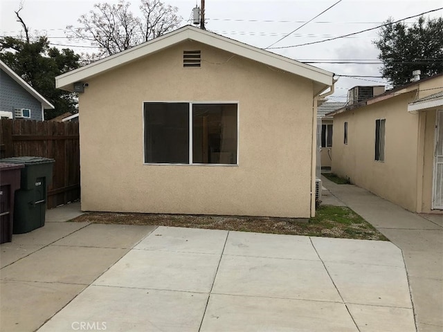 rear view of property with central AC and a patio area