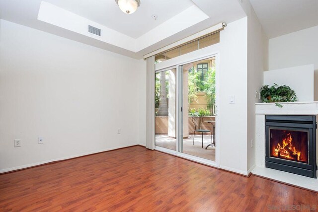 interior space featuring hardwood / wood-style floors and a tray ceiling