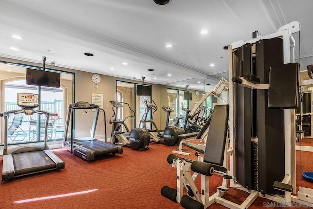 workout area with crown molding and carpet floors