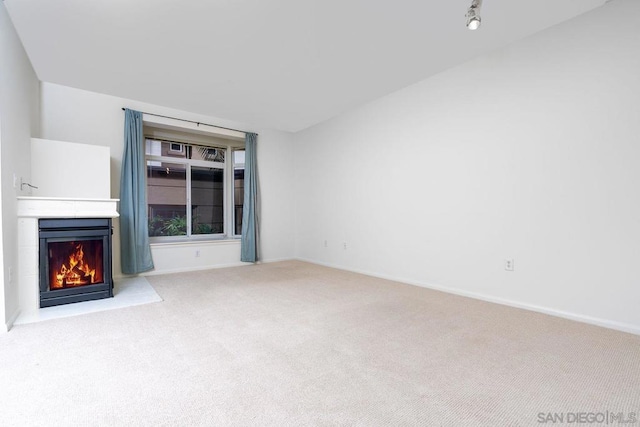 unfurnished living room featuring light carpet