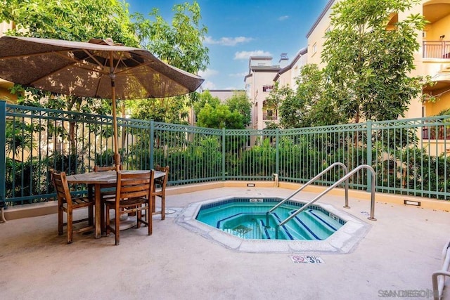 view of pool featuring a hot tub and a patio