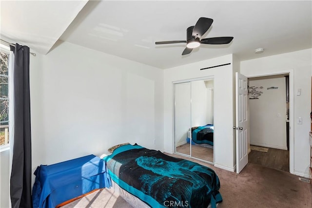 bedroom with ceiling fan, a closet, and carpet floors