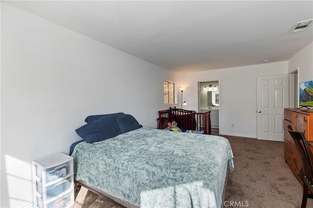 carpeted bedroom featuring connected bathroom