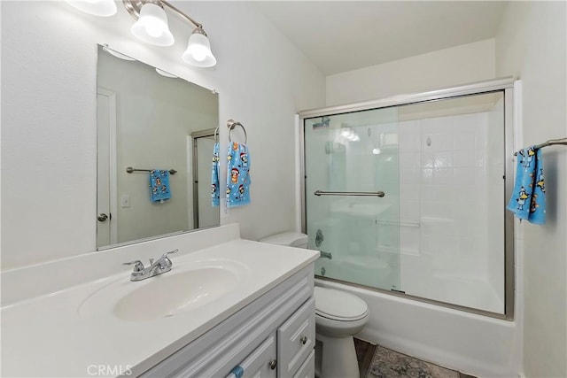 full bathroom featuring toilet, enclosed tub / shower combo, and vanity