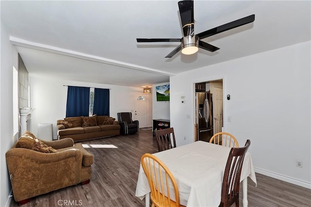 dining area with ceiling fan and dark wood-type flooring