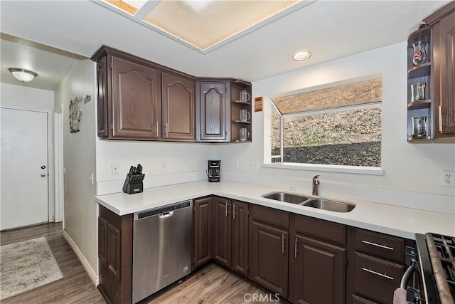 kitchen featuring sink, dark brown cabinetry, stainless steel appliances, and light wood-type flooring