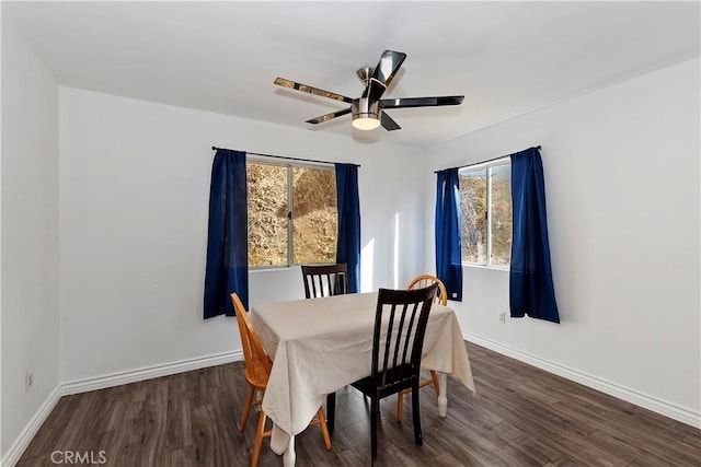 dining room with ceiling fan, dark wood-type flooring, and a healthy amount of sunlight