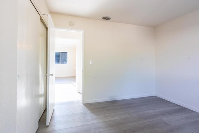 unfurnished room featuring hardwood / wood-style flooring