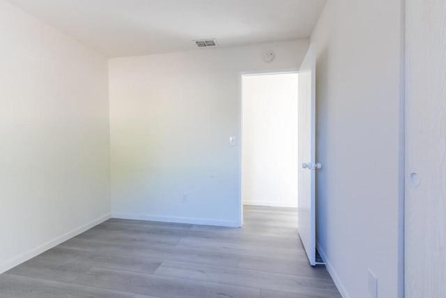 spare room featuring light hardwood / wood-style flooring