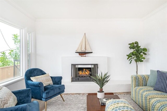 living room featuring a wealth of natural light, crown molding, and hardwood / wood-style floors