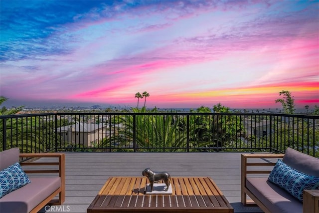 deck at dusk with outdoor lounge area