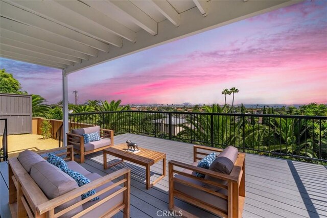 deck at dusk featuring an outdoor hangout area