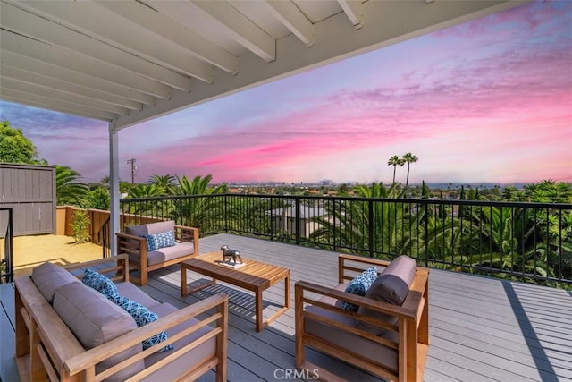 deck at dusk with outdoor lounge area