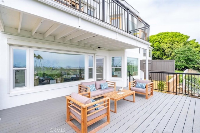 wooden terrace with an outdoor hangout area