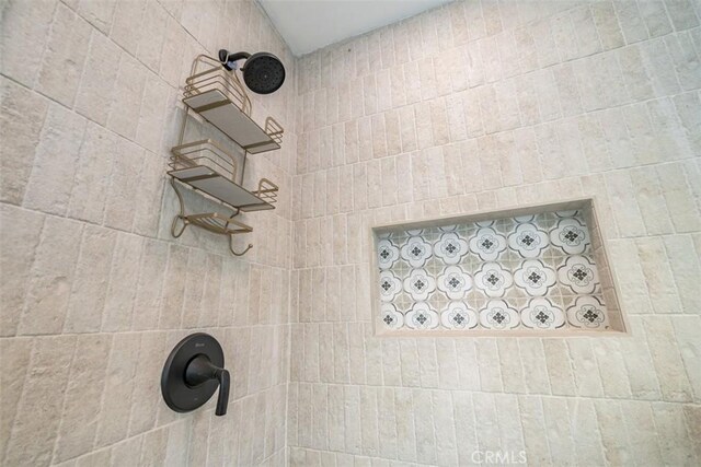 bathroom with tiled shower