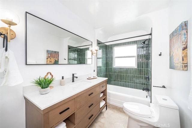 full bathroom featuring vanity, tiled shower / bath, and toilet