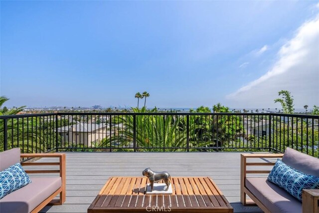 wooden terrace with an outdoor hangout area