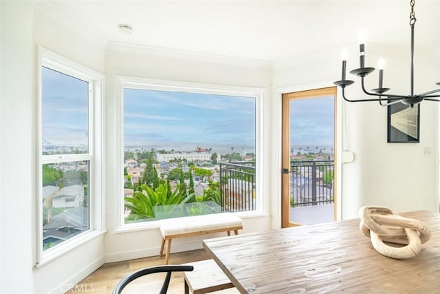 sunroom / solarium featuring a notable chandelier