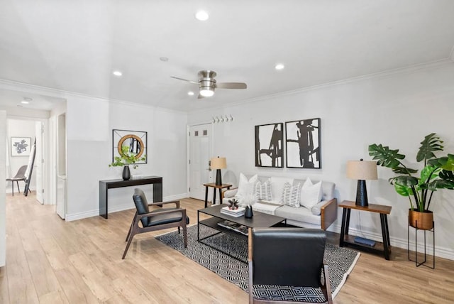 living room with ceiling fan, crown molding, and light hardwood / wood-style floors