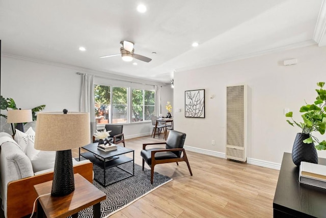 living room featuring ceiling fan, crown molding, and light hardwood / wood-style floors