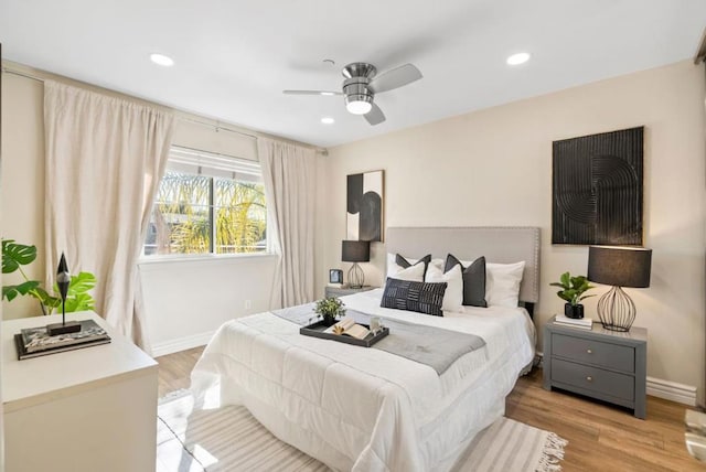 bedroom featuring ceiling fan and light hardwood / wood-style floors