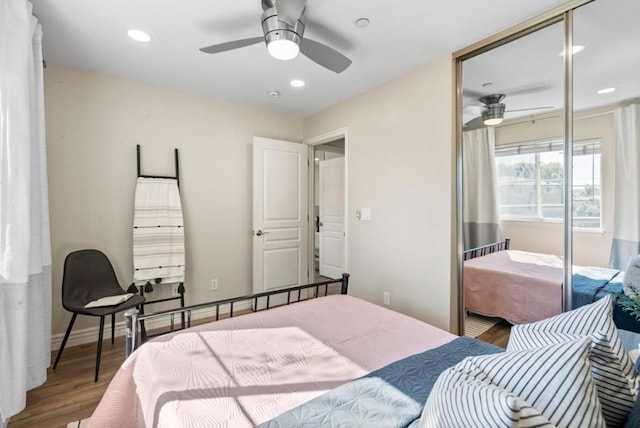 bedroom featuring ceiling fan, hardwood / wood-style flooring, and a closet