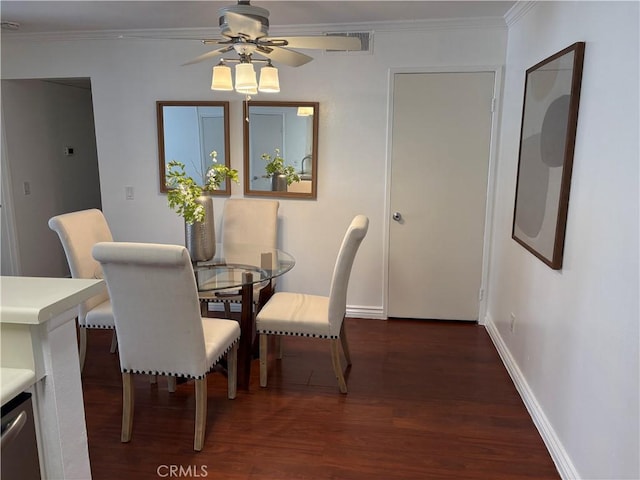 dining space with ceiling fan, dark hardwood / wood-style floors, and ornamental molding