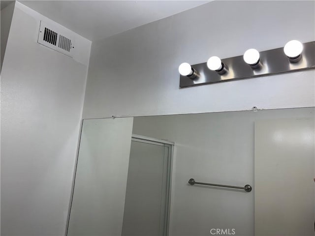 bathroom featuring a shower with door