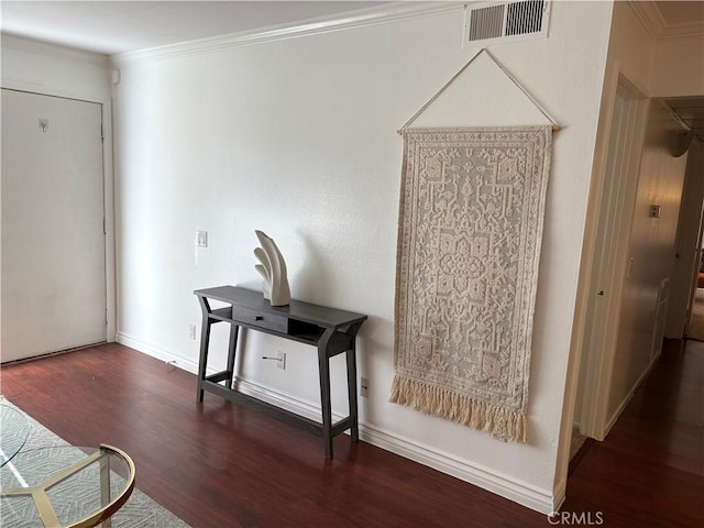 entrance foyer with dark hardwood / wood-style flooring and ornamental molding