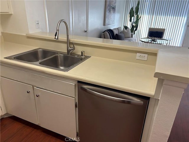 kitchen with stainless steel dishwasher, dark hardwood / wood-style floors, sink, and white cabinetry