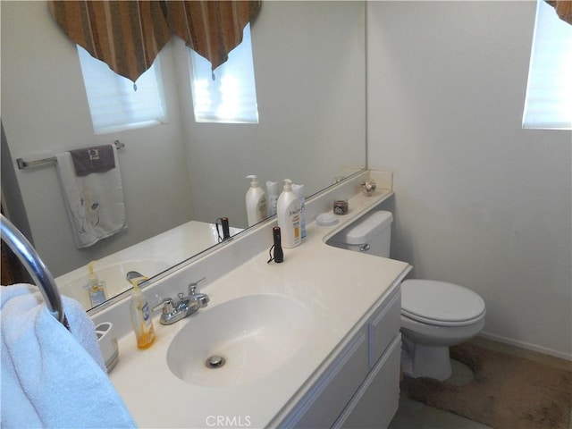 bathroom with vanity, plenty of natural light, and toilet