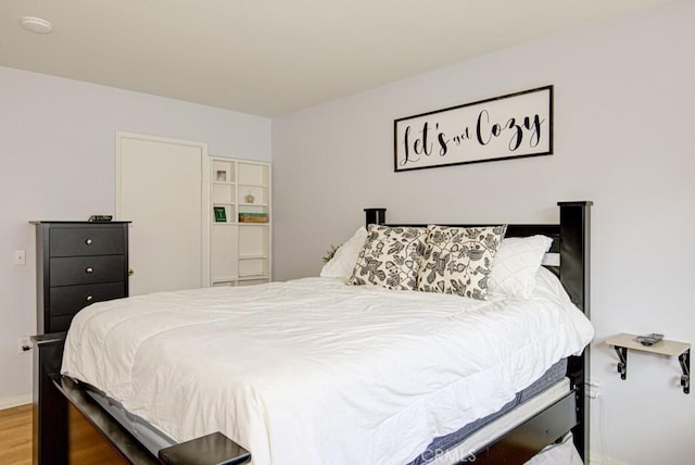 bedroom with wood-type flooring