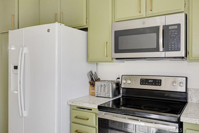 kitchen featuring stainless steel appliances and green cabinetry