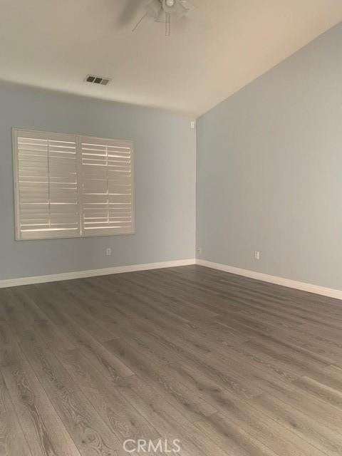 unfurnished room featuring ceiling fan and hardwood / wood-style floors