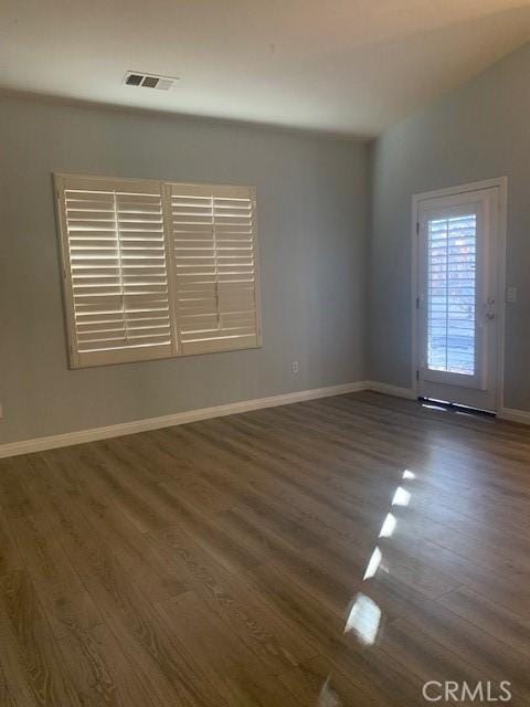 spare room featuring dark hardwood / wood-style flooring