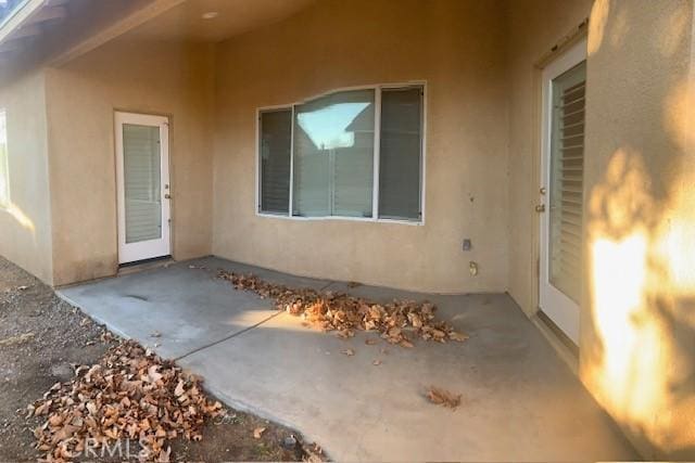 property entrance with a patio area