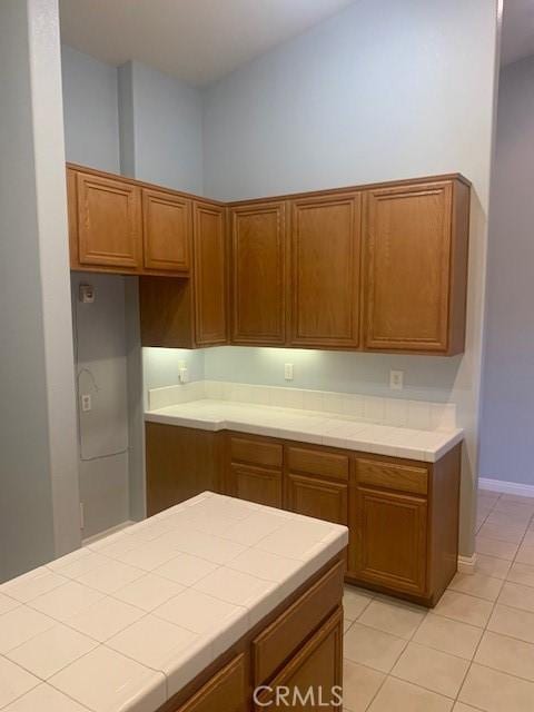 kitchen featuring light tile patterned floors and tile counters